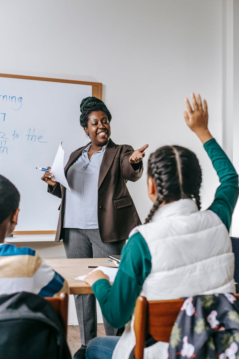 Black teacher answering questions of pupil